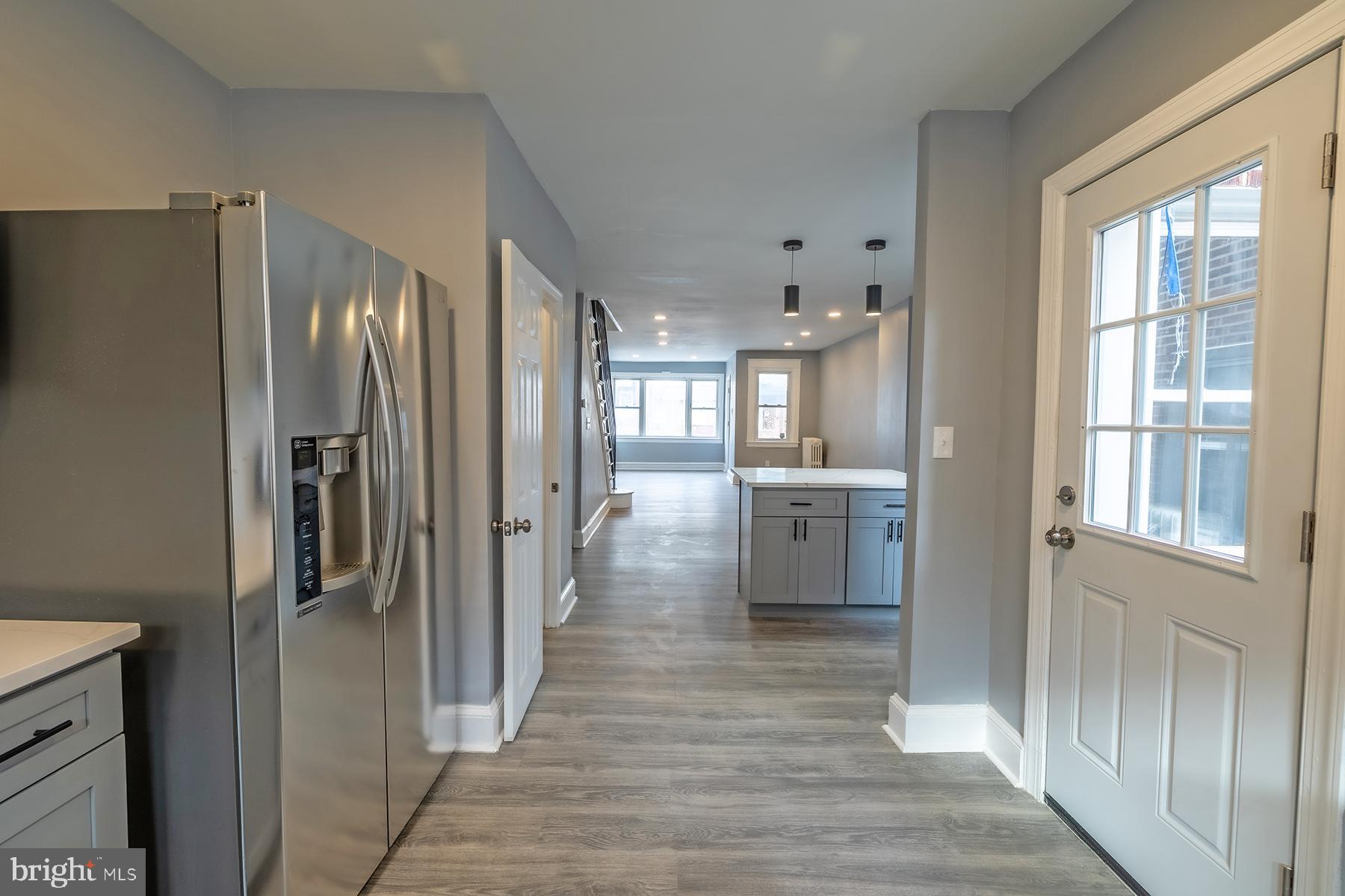 3104 Stirling Street Philadelphia, PA 19149 - Photo 11 of 27 a view of a hallway with wooden floor and a kitchen