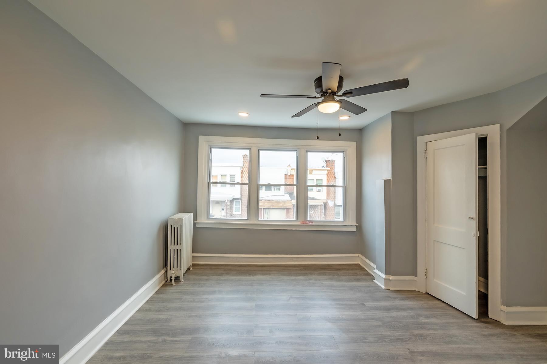 3104 Stirling Street Philadelphia, PA 19149 - Photo 15 of 27 an empty room with wooden floor and windows