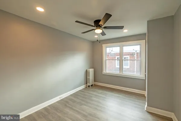 a view of a livingroom with a ceiling fan and window