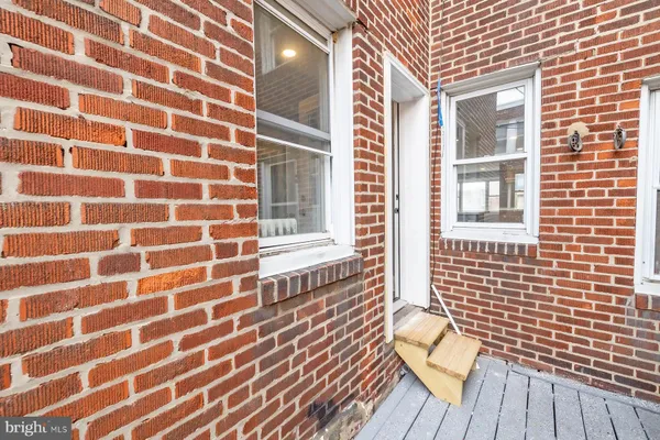 a view of a brick wall with a large window