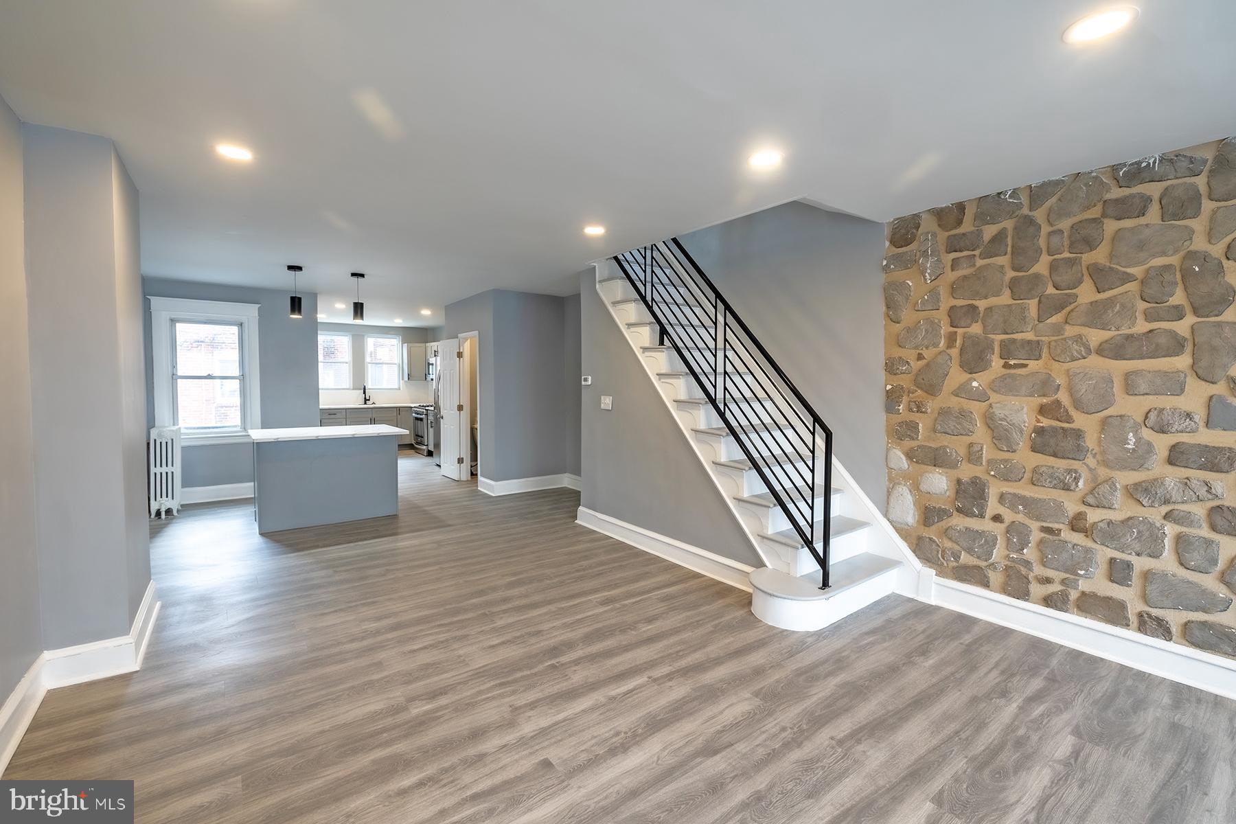 3104 Stirling Street Philadelphia, PA 19149 - Photo 3 of 27 an empty room with wooden floor windows and stairs