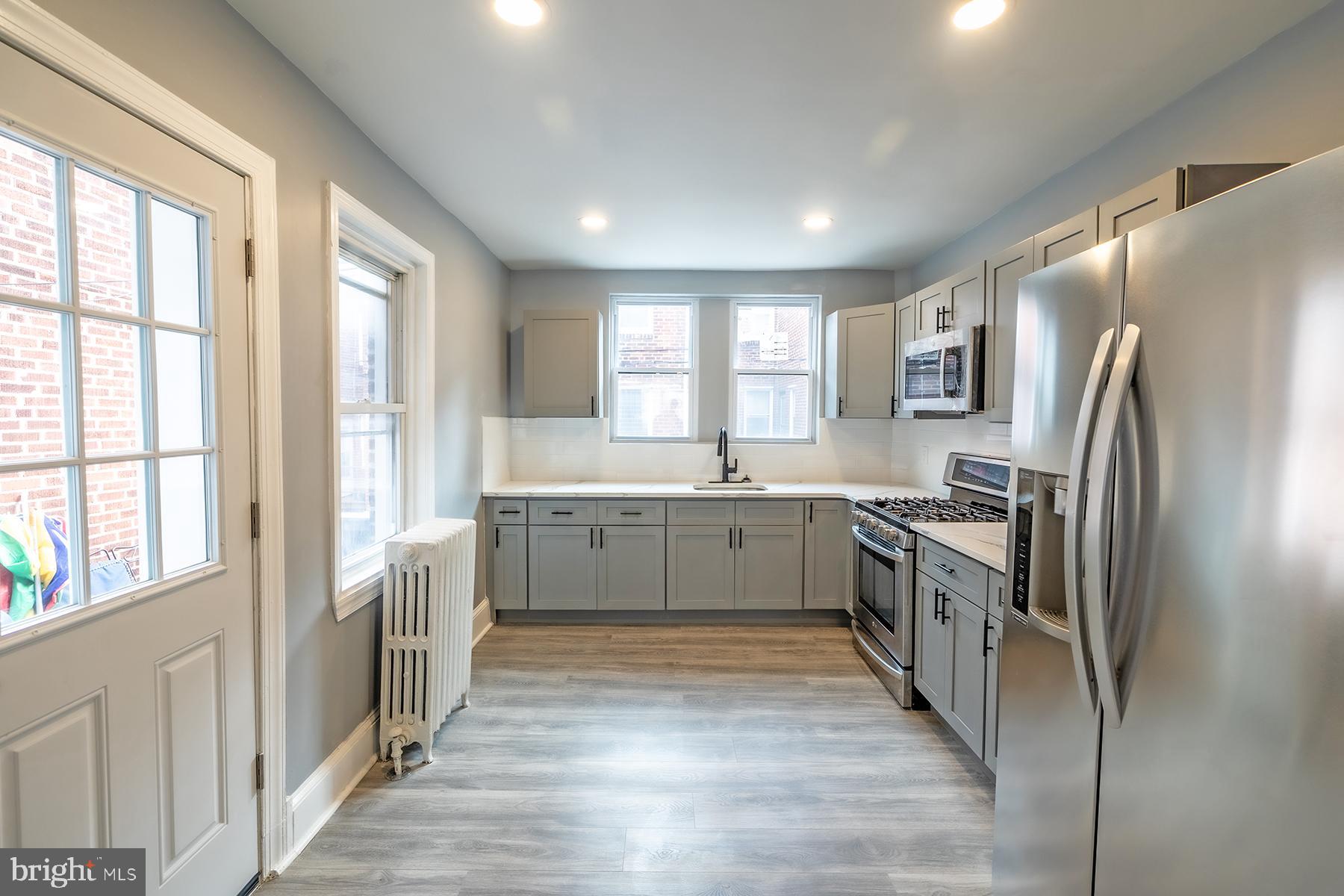 3104 Stirling Street Philadelphia, PA 19149 - Photo 10 of 27 a large kitchen with a large window and stainless steel appliances