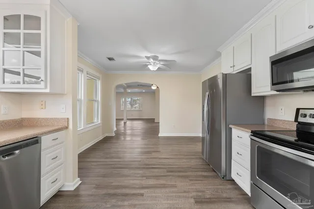 a kitchen with stainless steel appliances a stove microwave and refrigerator