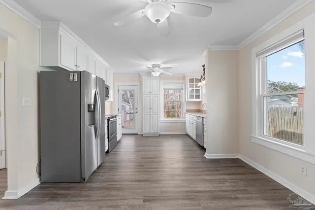 a view of a kitchen with wooden floor and a refrigerator