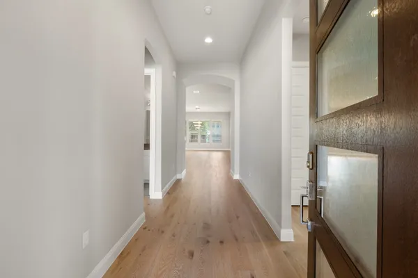 a view of a hallway with wooden floor