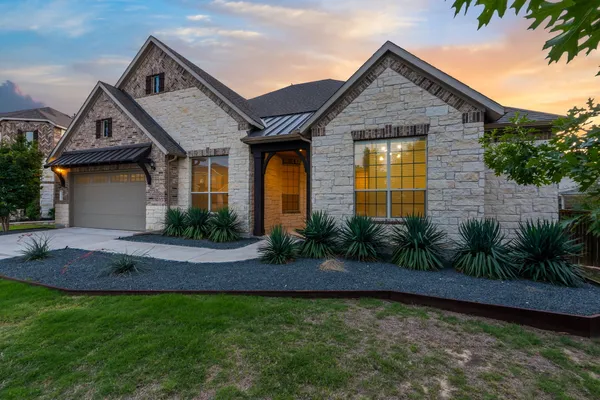 a view of a house with a backyard