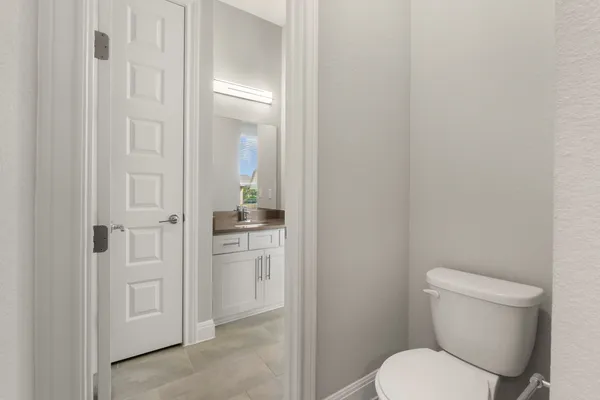 a white toilet sitting next to a bathroom sink