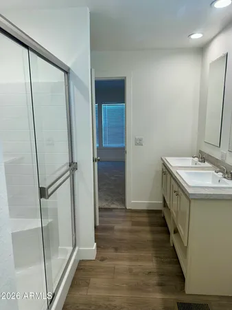 a bathroom with a double vanity sink and a mirror