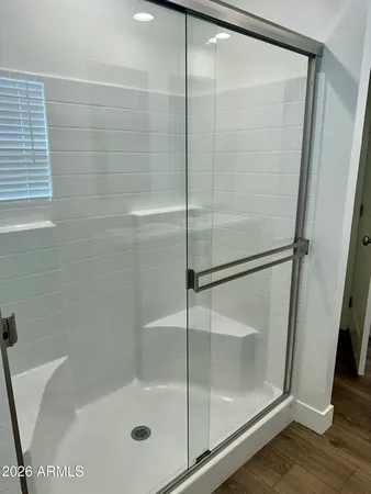 a bathroom with a glass shower door