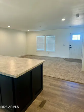 a view of kitchen with granite countertop cabinets and sink