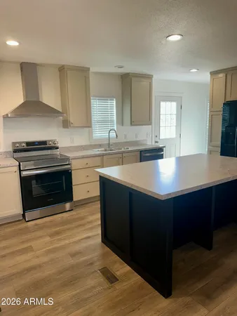 a kitchen with stainless steel appliances granite countertop a stove a sink and a microwave