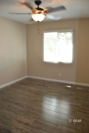 1352 Sydnor Avenue Ridgecrest, CA 93555 - Photo 11 of 26 a view of an empty room with wooden floor and a window