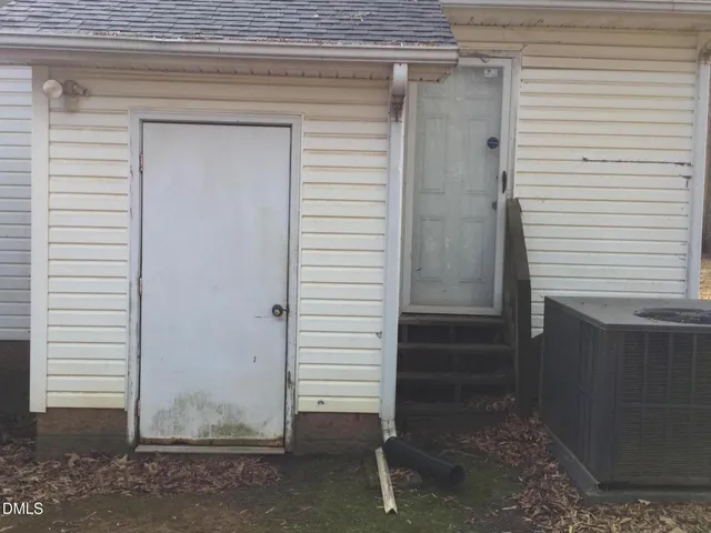 a view of a house with a small backyard
