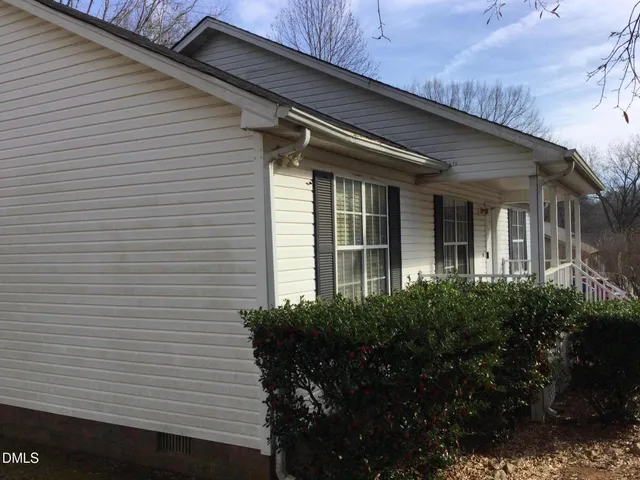 a view of brick house with potted plants