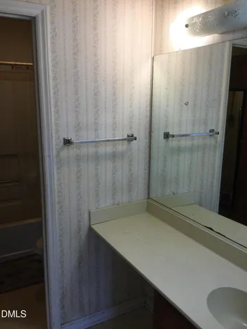 a bathroom with a shower and a sink