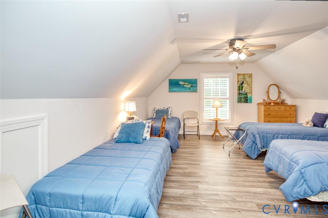 7075 Menzels Road Toano, VA 23168 - Photo 44 of 50 Vaulted ceiling with a ceiling fan, wood-finish fl