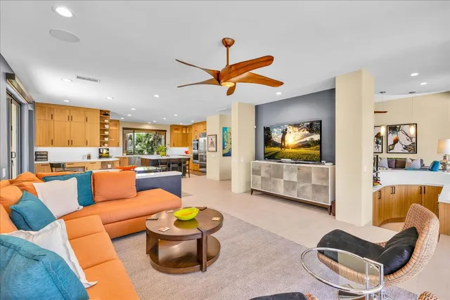 a dining room with furniture a chandelier and window