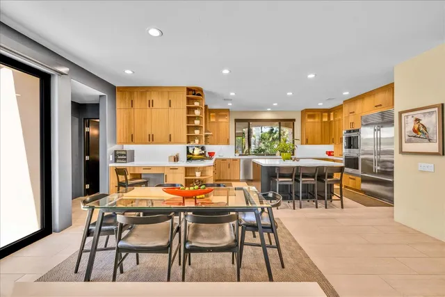a bedroom with a bed and large glass window