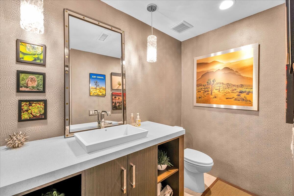 45730 Indian Canyon Road Indian Wells, CA 92210 - Photo 20 of 71 a bathroom with a sink a toilet and mirror