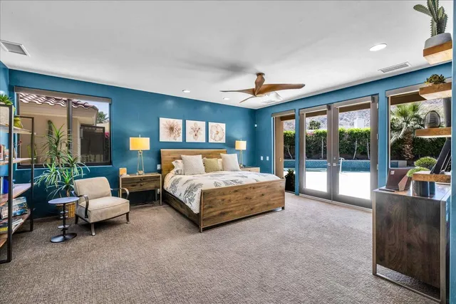 a bathroom with a granite countertop sink a toilet a mirror and shower