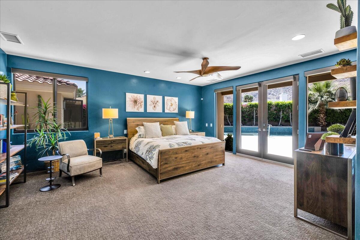 45730 Indian Canyon Road Indian Wells, CA 92210 - Photo 25 of 71 a bedroom with a bed and large glass window
