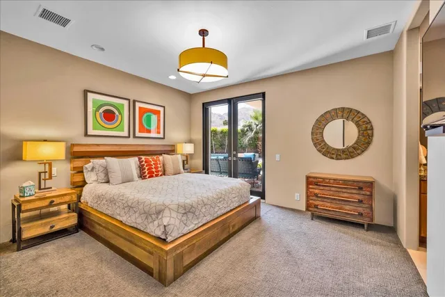 a view of a patio with couches table and chairs and potted plants