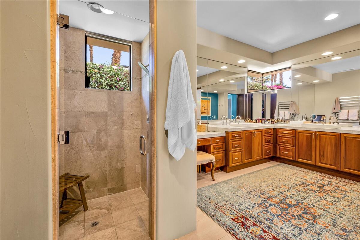 45730 Indian Canyon Road Indian Wells, CA 92210 - Photo 30 of 71 a bathroom with a tub a sink a mirror and shower
