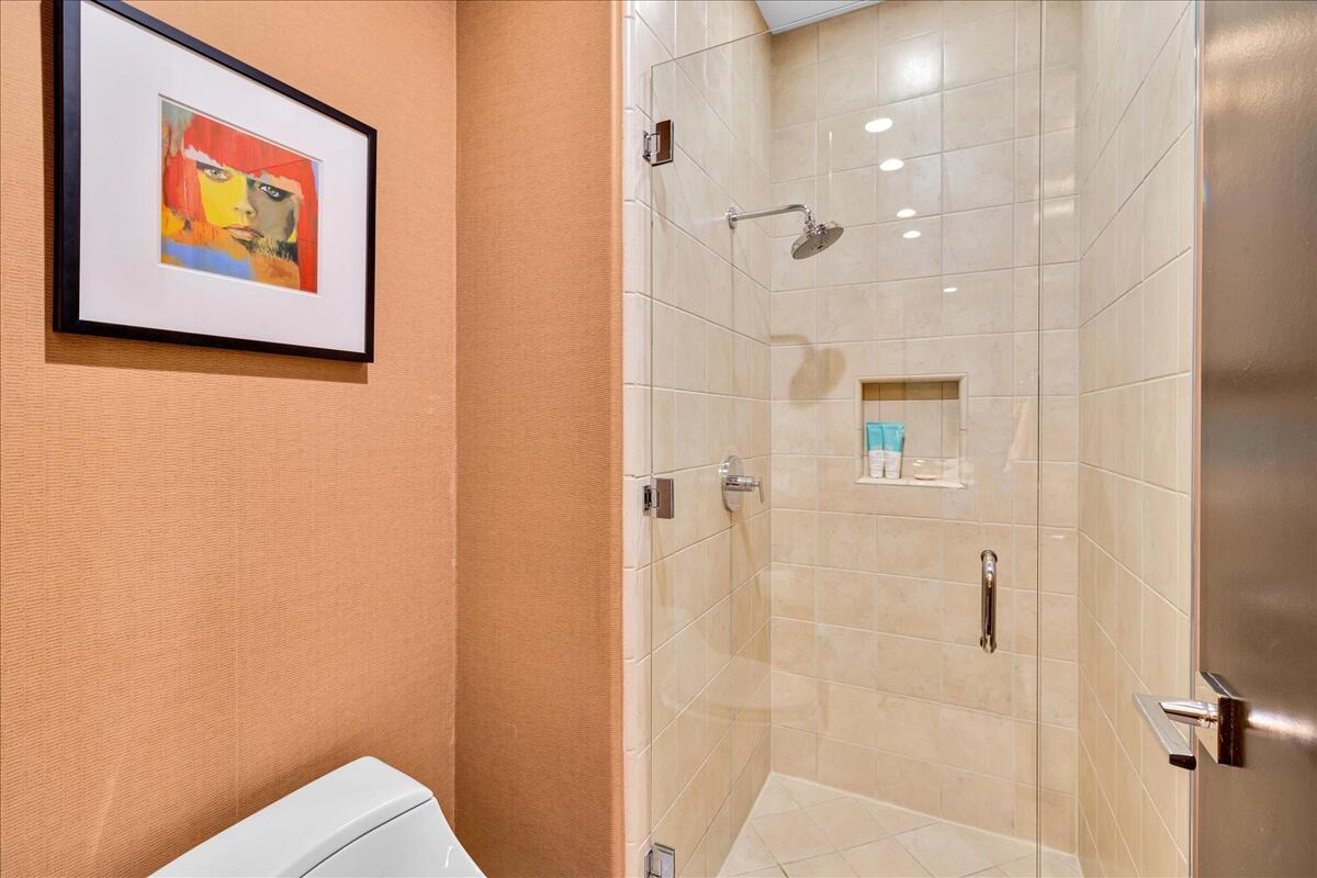 45730 Indian Canyon Road Indian Wells, CA 92210 - Photo 34 of 71 a bathroom with a painting on the wall and shower