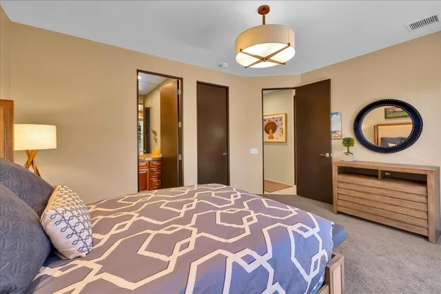 a view of an house with backyard and a tree