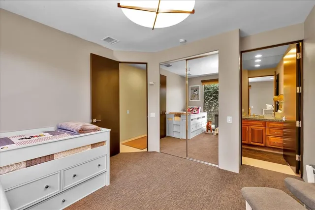 a view of a patio with dining table and chairs with potted plants and palm trees