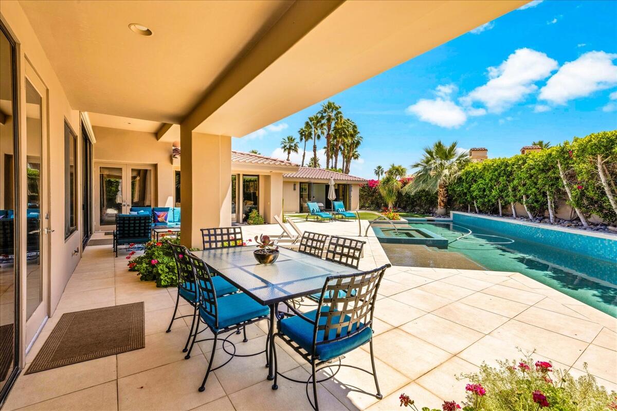 45730 Indian Canyon Road Indian Wells, CA 92210 - Photo 55 of 71 a view of a patio with a table and chairs