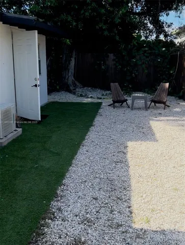 a view of backyard with seating space