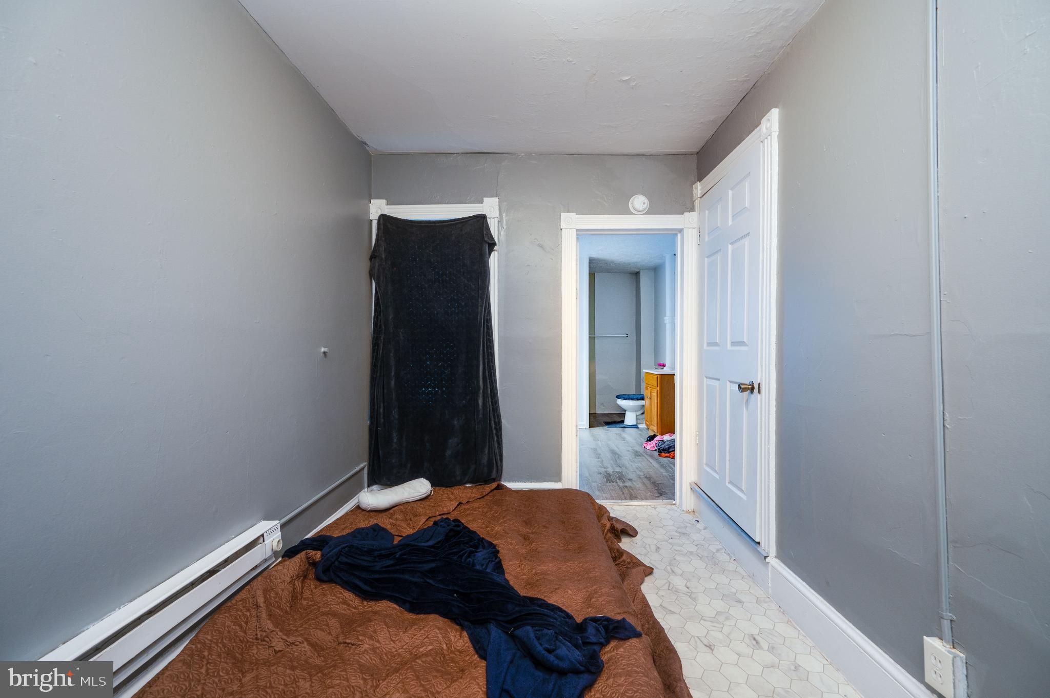 235 Hudson Street Reading, PA 19601 - Photo 15 of 25 a bed sitting in a bedroom next to a window and storage