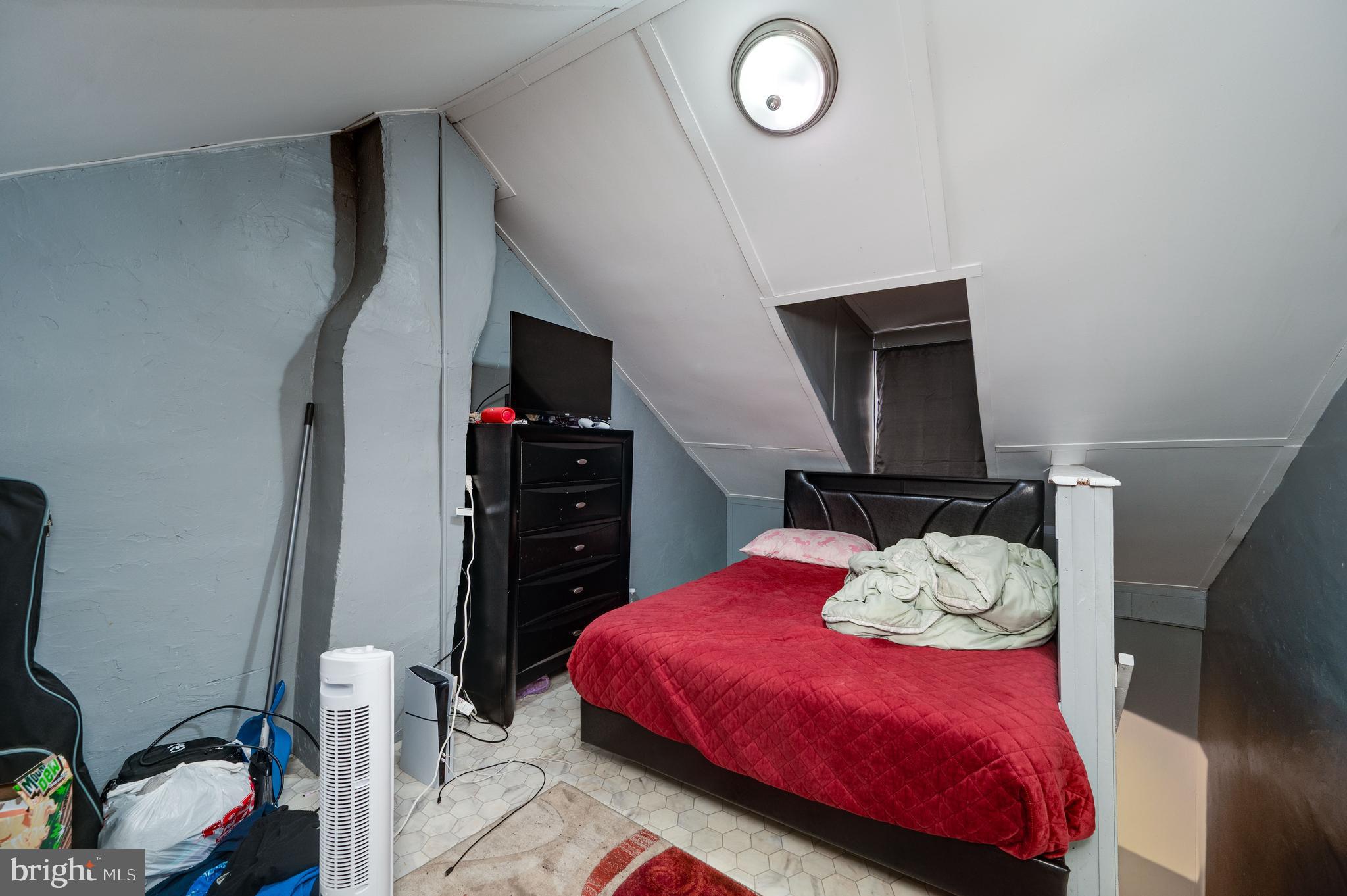 235 Hudson Street Reading, PA 19601 - Photo 21 of 25 a bedroom with a bed and a flat tv screen on the dresser
