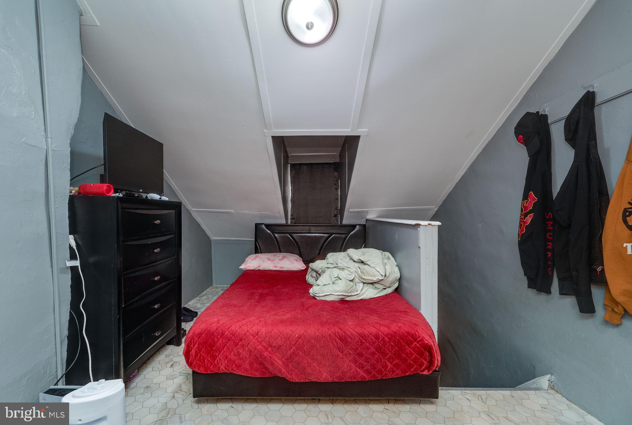 235 Hudson Street Reading, PA 19601 - Photo 22 of 25 a bedroom with a bed and a flat tv screen on the dresser
