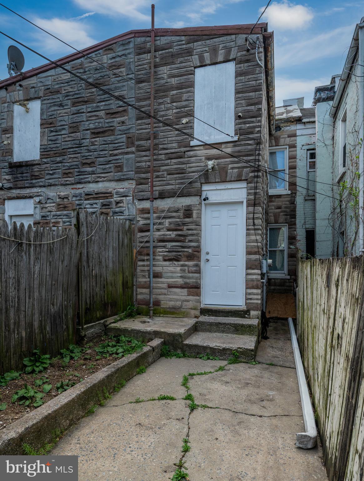 235 Hudson Street Reading, PA 19601 - Photo 25 of 25 a brick building with a small yard and a large window