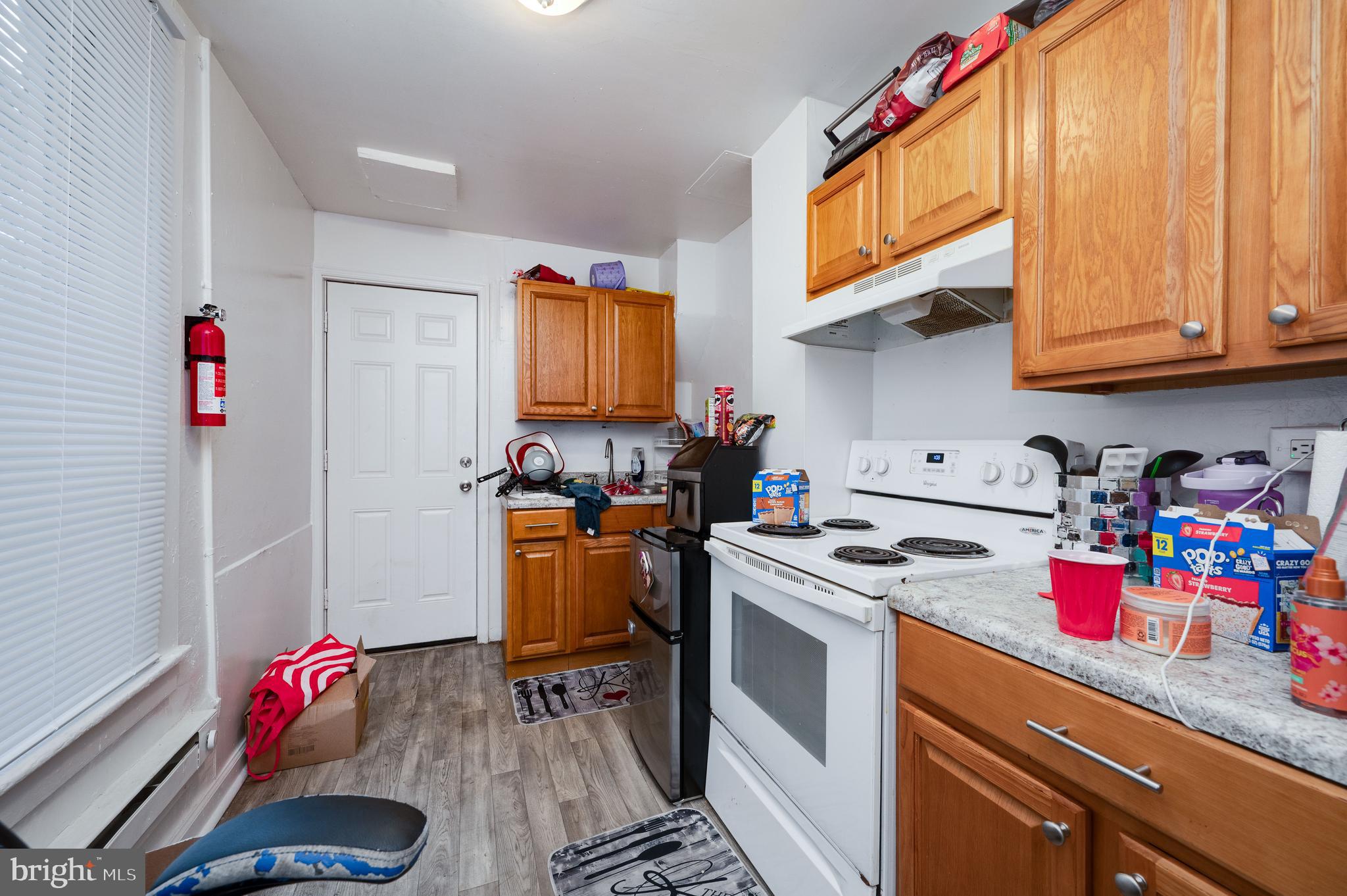 235 Hudson Street Reading, PA 19601 - Photo 8 of 25 a kitchen with a white stove top oven and cabinets