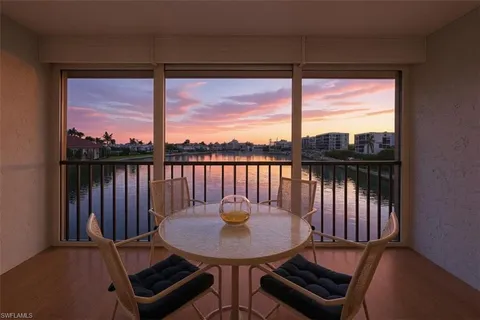 a view of a chair and table in the balcony