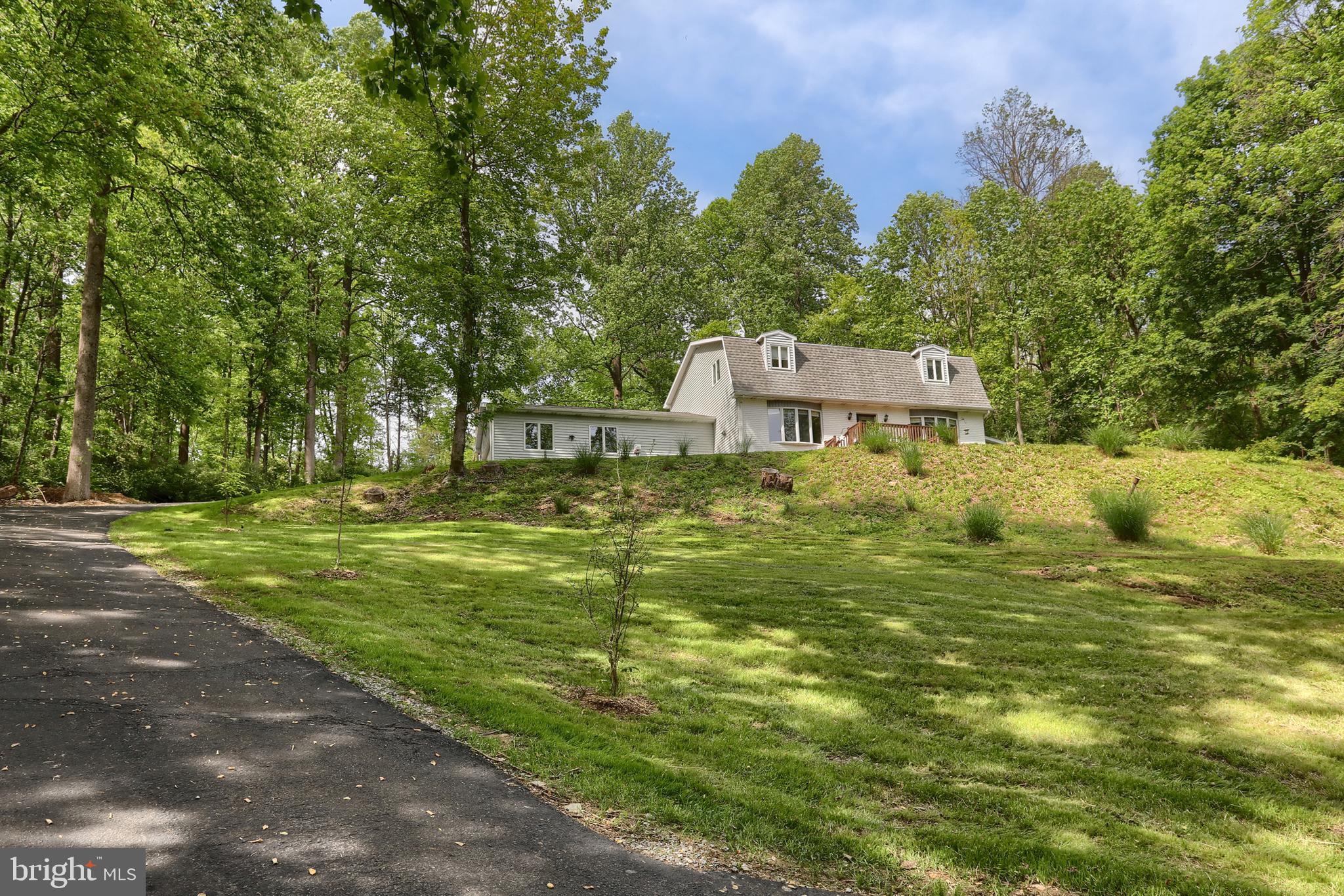 a backyard of a house with lots of green space and fountain