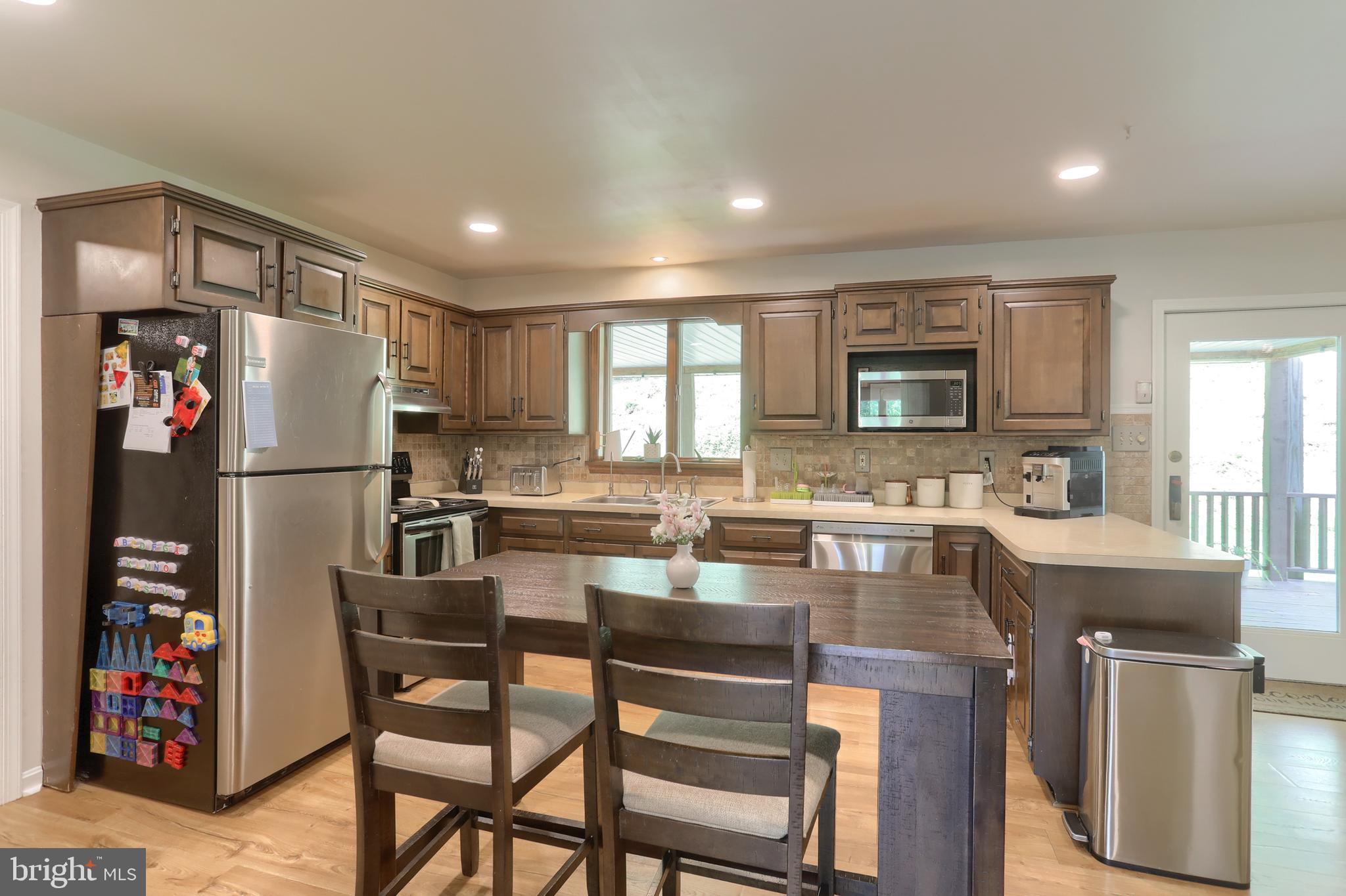 46 Gelsinger Road Reading, PA 19608 - Photo 8 of 50 a kitchen with refrigerator a sink and chairs