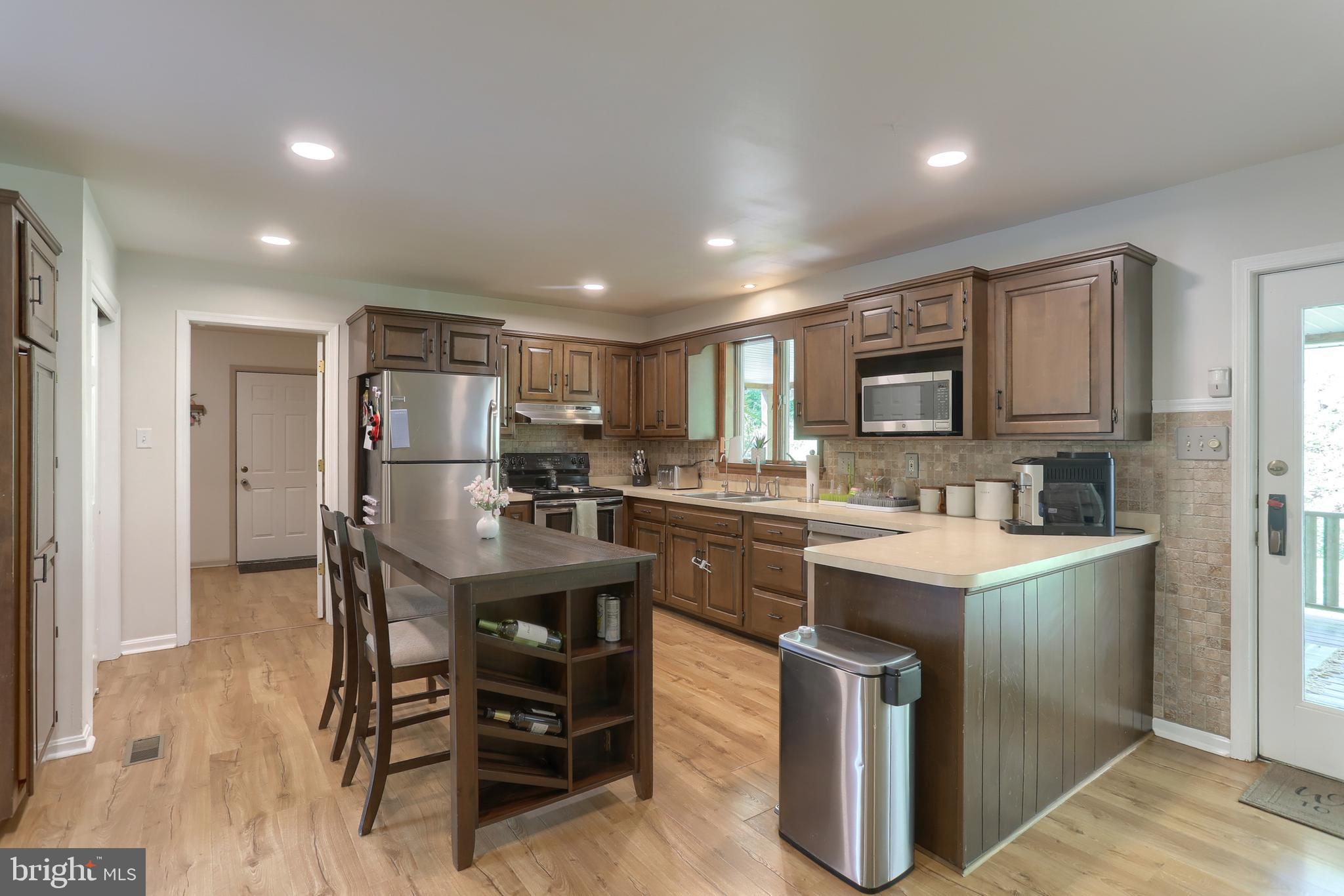 46 Gelsinger Road Reading, PA 19608 - Photo 9 of 50 a kitchen with kitchen island a sink table and chairs