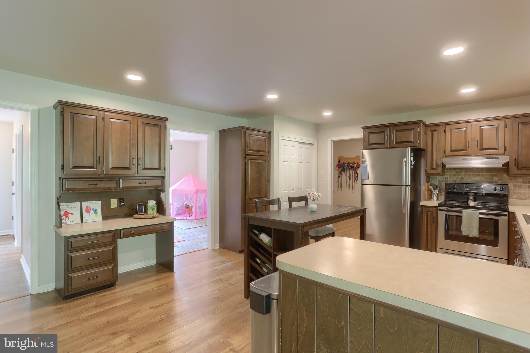 46 Gelsinger Road Reading, PA 19608 - Photo 10 of 50 a kitchen with kitchen island stainless steel appliances a stove refrigerator sink and cabinets