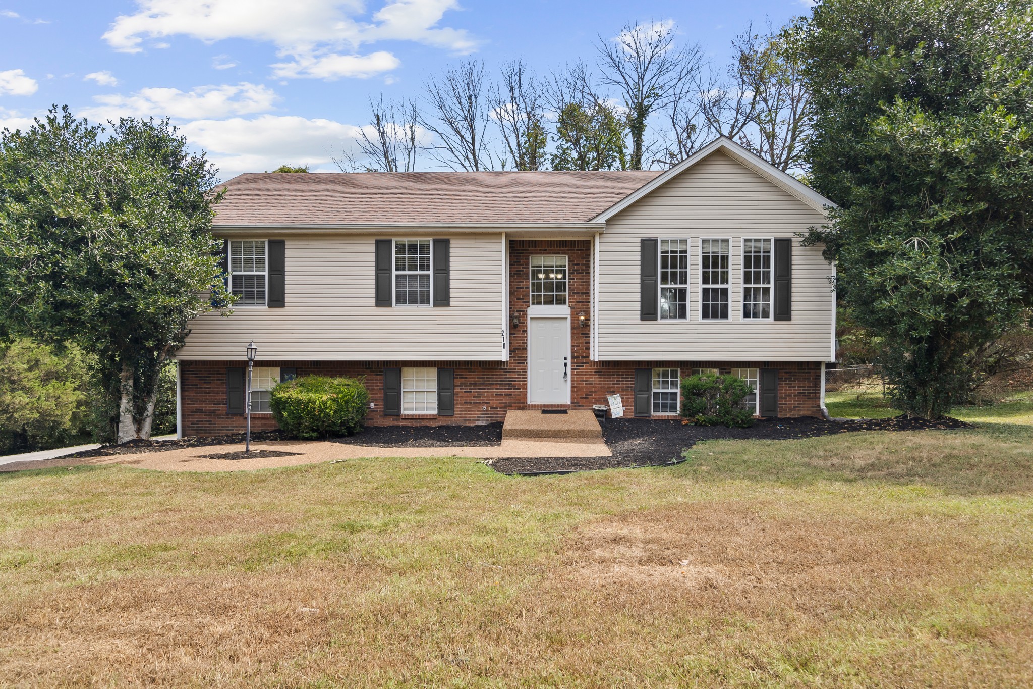 a front view of a house with a yard