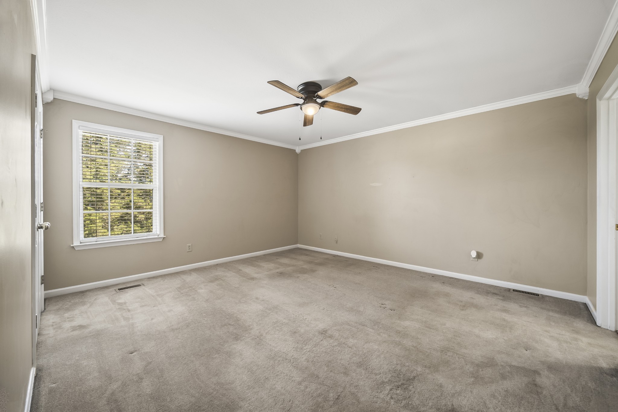 210 Winding Way Columbia, TN 38401 - Photo 7 of 28 an empty room with a chandelier fan and windows