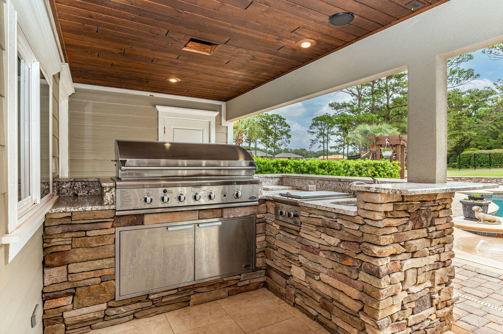 2767 Phil Tyner Road Crestview, FL 32536 - Photo 104 of 176 a kitchen with kitchen island a stove a chimney and a large window