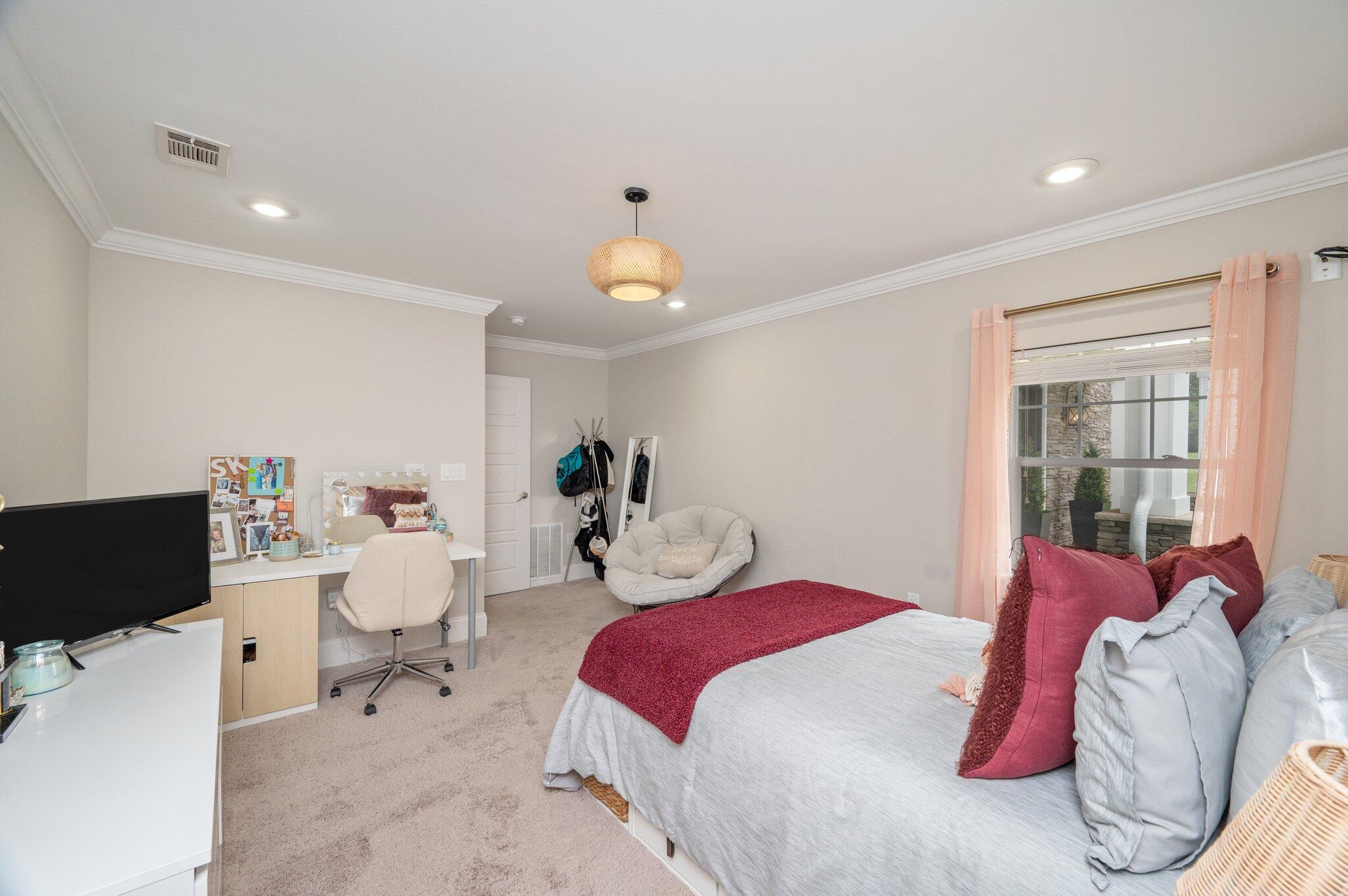 2767 Phil Tyner Road Crestview, FL 32536 - Photo 53 of 176 a bedroom with a bed and a chandelier