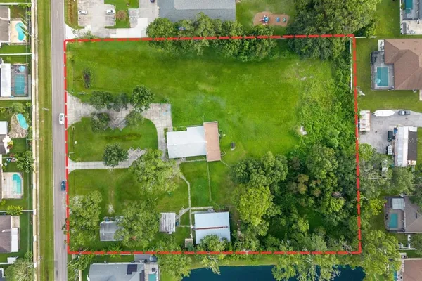 an aerial view of house with yard swimming pool and outdoor seating