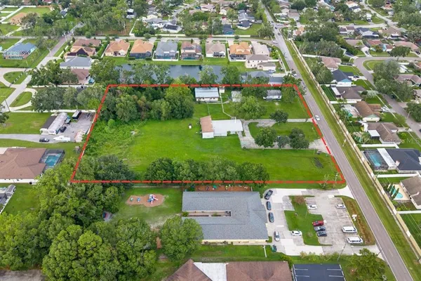 an aerial view of residential houses with outdoor space and street view