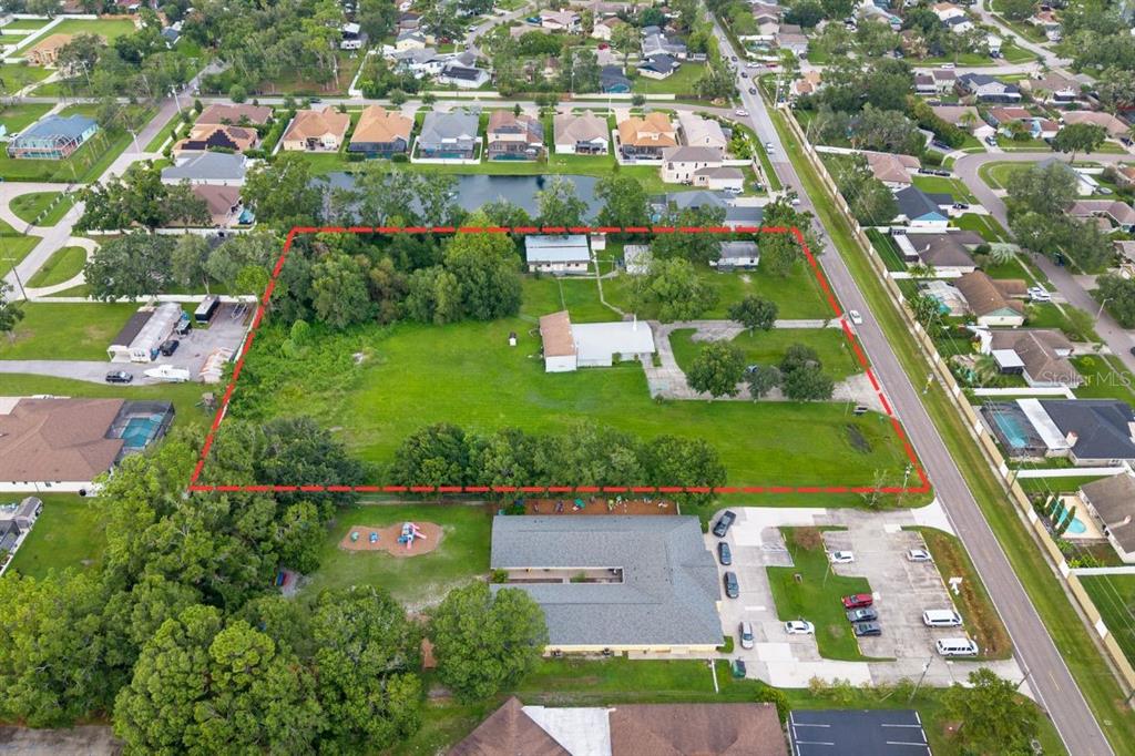 15402 Casey Road Tampa, FL 33624 - Photo 4 of 9 an aerial view of residential houses with outdoor space and street view