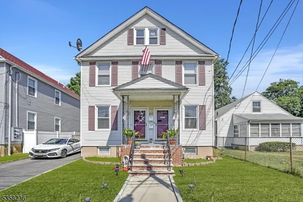 a front view of a house with a garden and porch